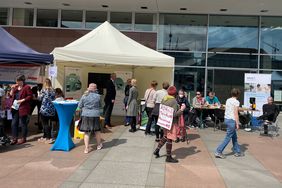 Viele Besucher*innen und Teilnehmende stehen vor den St&auml;nden des Landesbeauftragter f&uuml;r Inklusion der Menschen mit Behinderungen und des BSVS und sehen sich diese an. Manuela Scharf und Michael Welsch stehen ebenfalls an den St&auml;nden.