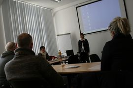 Referentin vor Leinwand - Blick von den sitzenden Teilnehmern aus